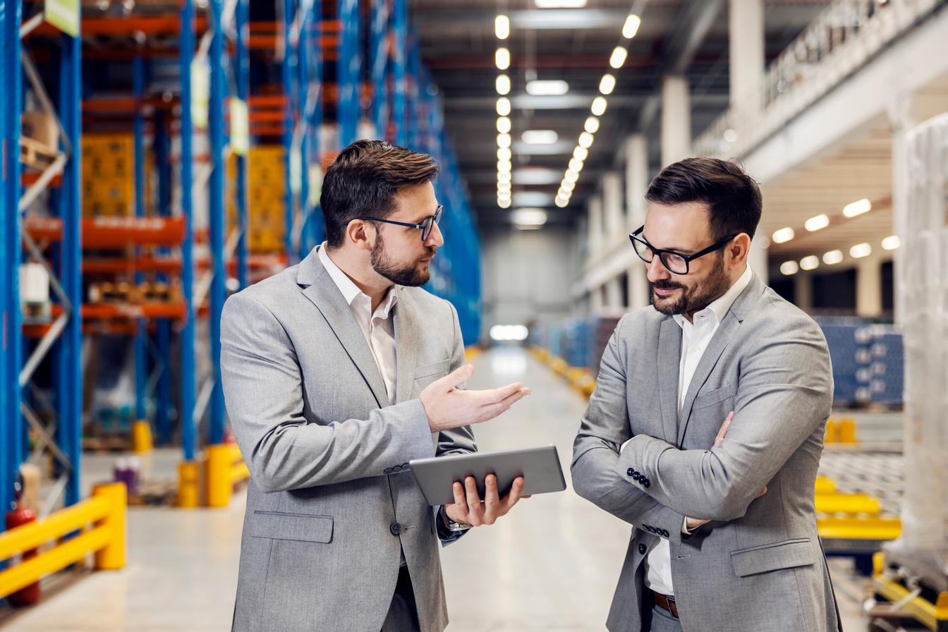 Businesspeople talking and having negotiations in warehouse.