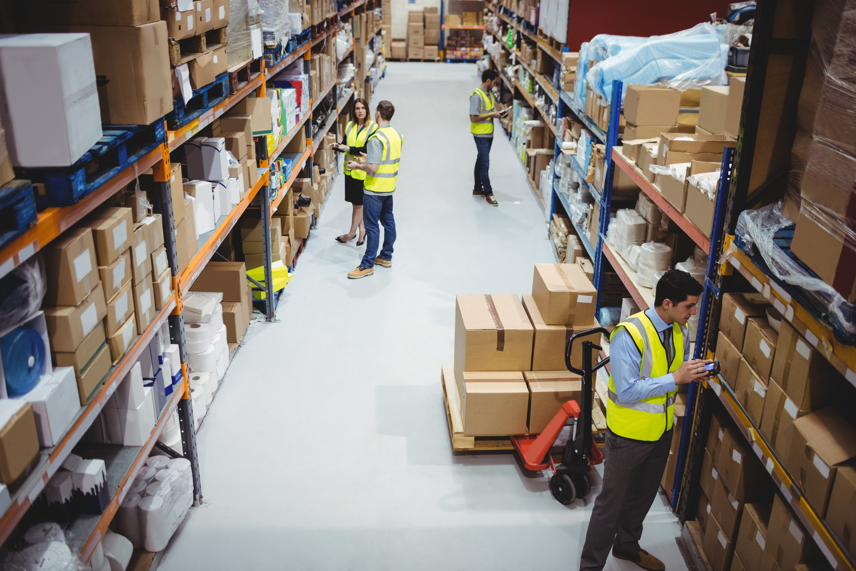 Warehouse worker using hand scanner